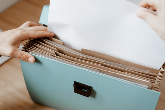 person looking through file folder