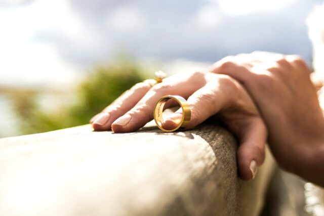 person holding wedding band