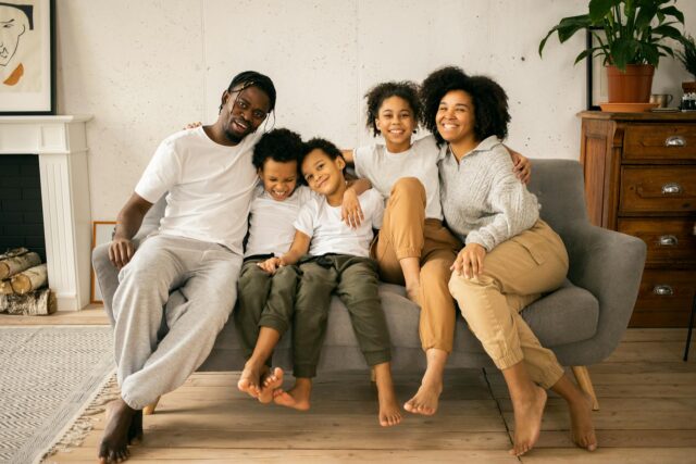 family sitting on couch smiling