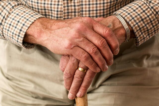 elderly man holding cane
