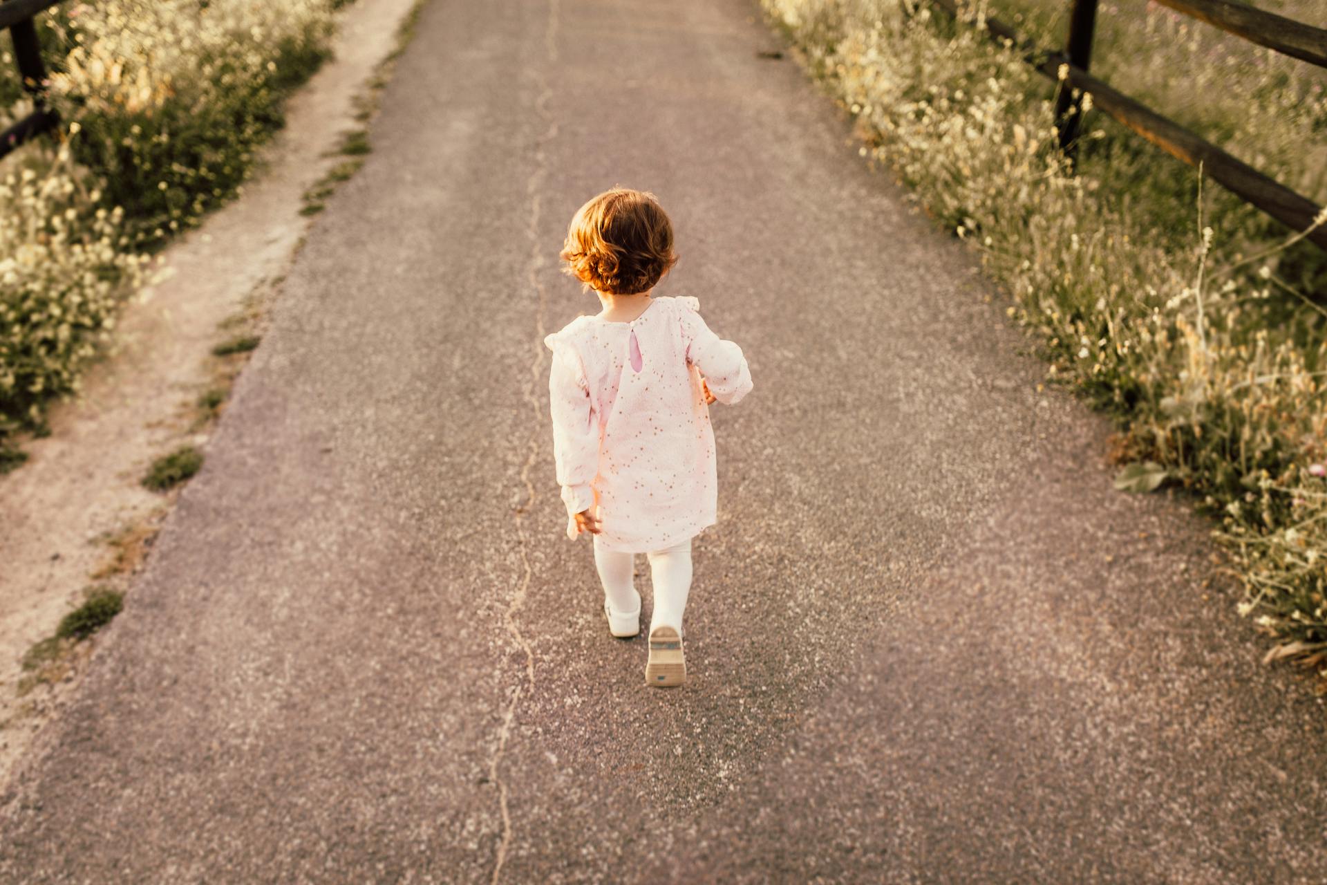 child walking down a road